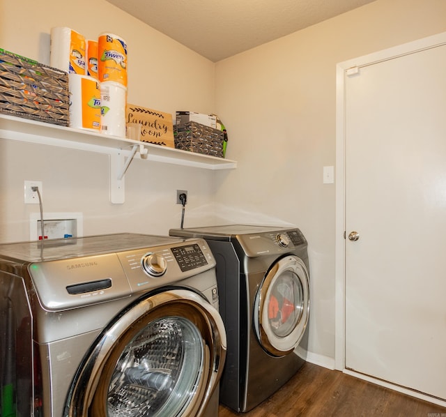 laundry room with washer and dryer, laundry area, and wood finished floors