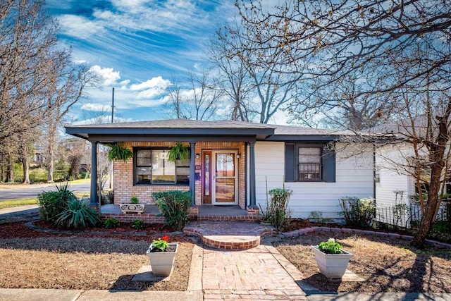 view of front of house featuring covered porch and brick siding