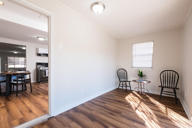 sitting room with a healthy amount of sunlight, baseboards, and wood finished floors