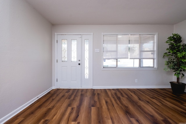 entrance foyer featuring dark wood-style floors and baseboards