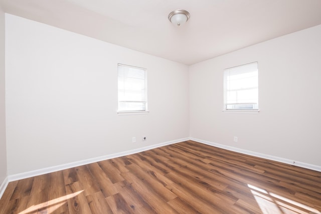 unfurnished room featuring wood finished floors and baseboards