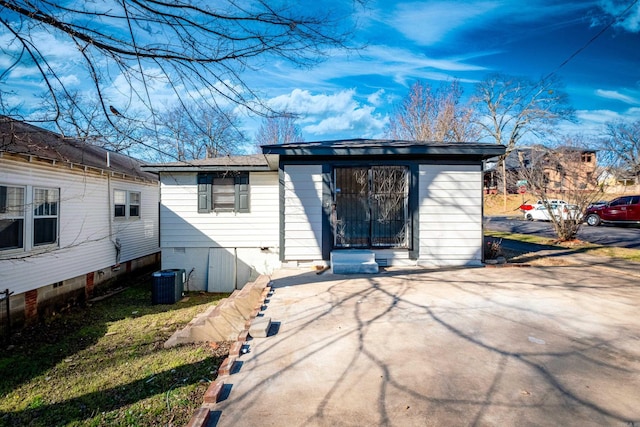 back of property with crawl space and central AC