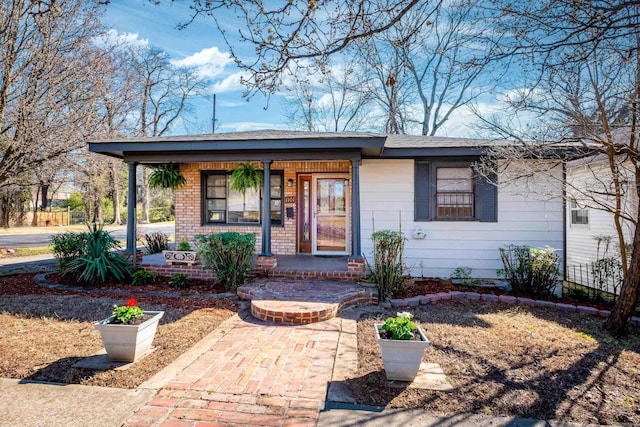 view of front facade featuring a porch and brick siding