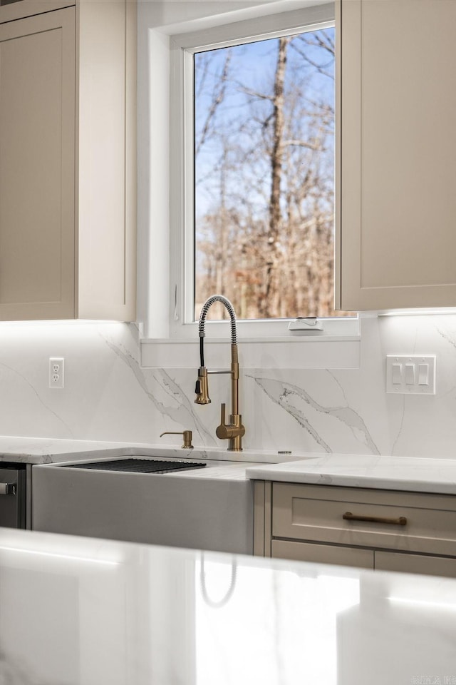 details with tasteful backsplash, light stone counters, and a sink