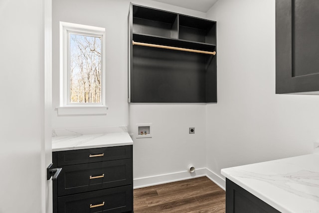 washroom with dark wood finished floors, a wealth of natural light, cabinet space, and hookup for an electric dryer