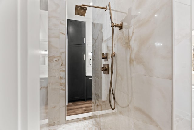 full bath with a marble finish shower