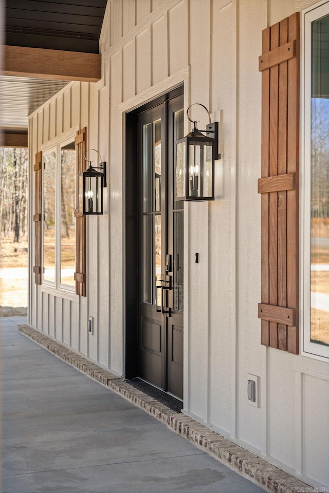 view of exterior entry with board and batten siding