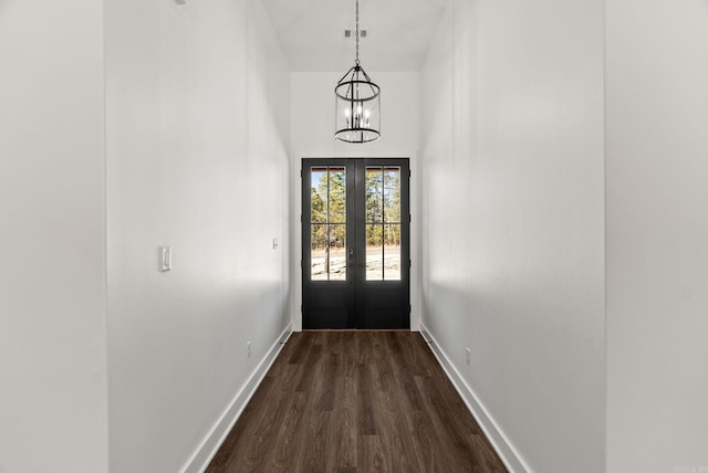 doorway with visible vents, french doors, an inviting chandelier, baseboards, and dark wood-style flooring