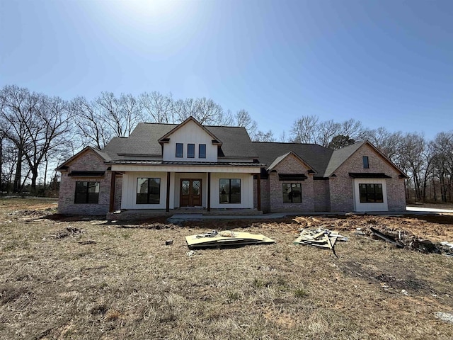 modern farmhouse style home featuring brick siding and board and batten siding