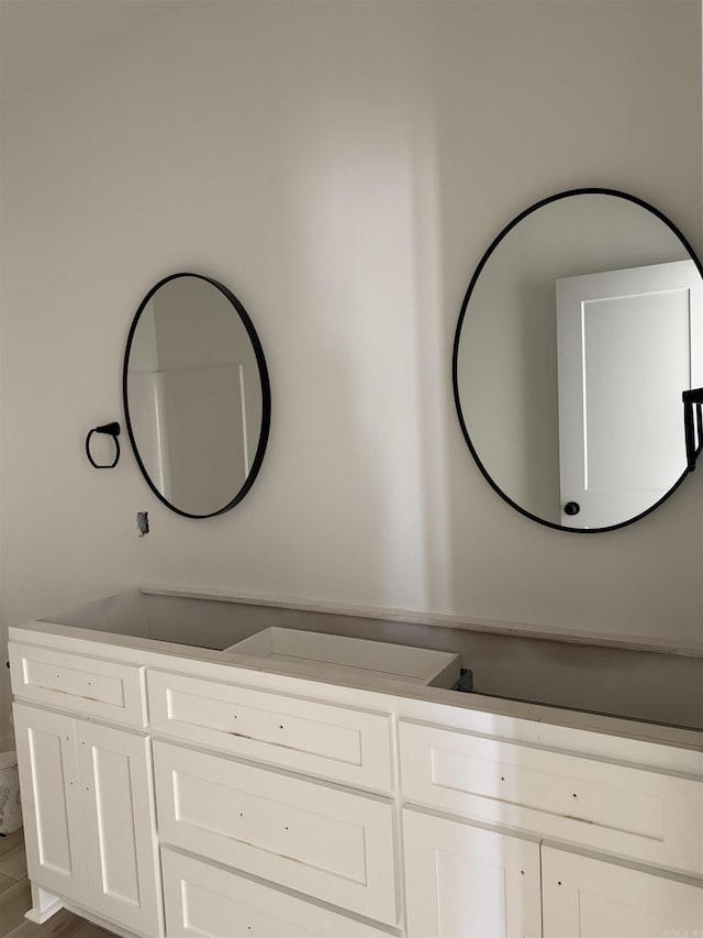 bathroom with wood finished floors and vanity