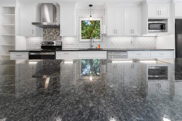 kitchen featuring a sink, open shelves, white cabinetry, stainless steel appliances, and wall chimney range hood