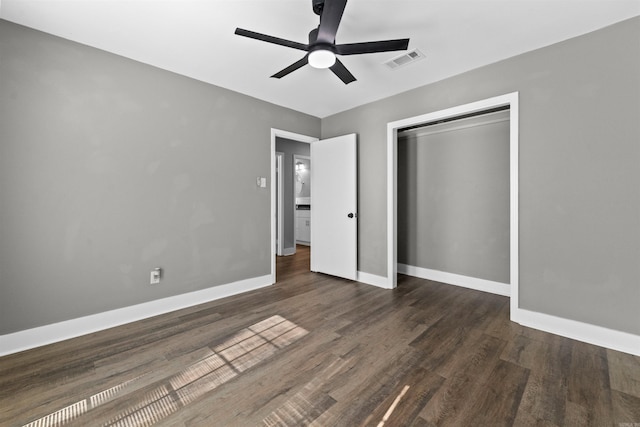 unfurnished bedroom featuring visible vents, wood finished floors, a closet, baseboards, and ceiling fan