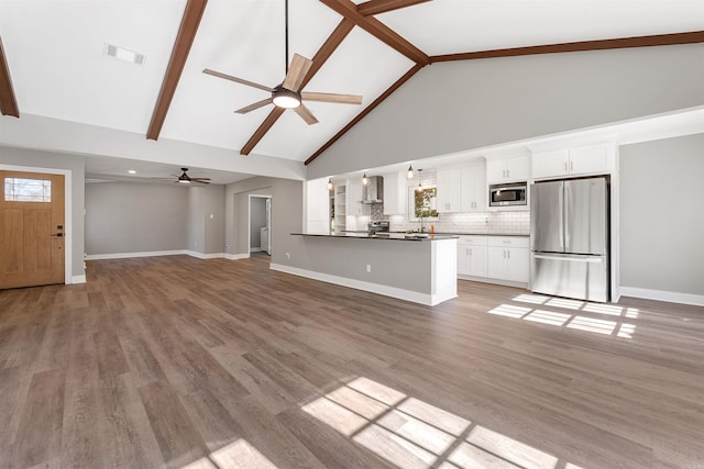 unfurnished living room featuring visible vents, beamed ceiling, high vaulted ceiling, light wood-style flooring, and baseboards