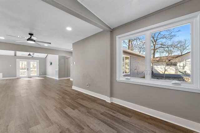 unfurnished living room with visible vents, french doors, baseboards, and wood finished floors