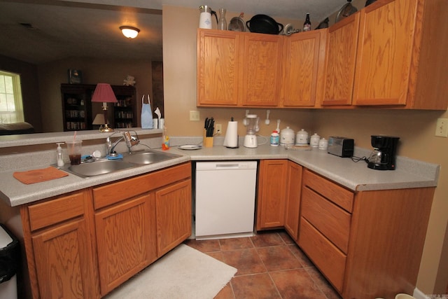 kitchen with dishwasher, light countertops, and a sink