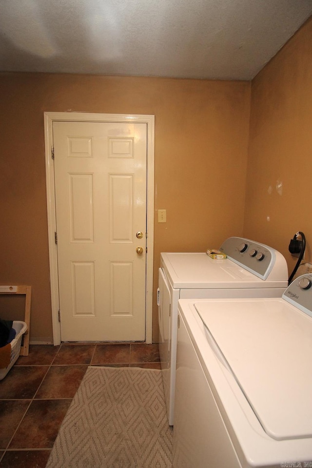 washroom with tile patterned floors, laundry area, and washer and dryer