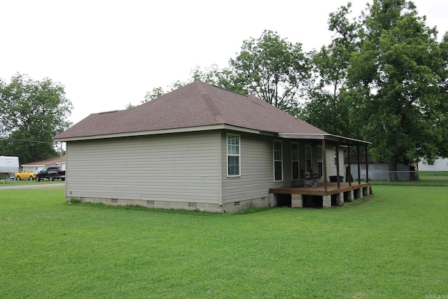 view of property exterior with crawl space, a lawn, and a shingled roof