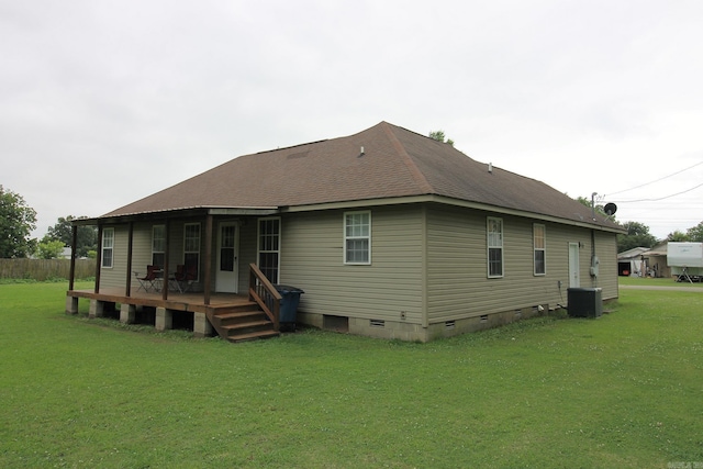 back of property featuring central air condition unit, a lawn, a wooden deck, a shingled roof, and crawl space