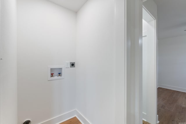 laundry area featuring electric dryer hookup, washer hookup, wood finished floors, and laundry area