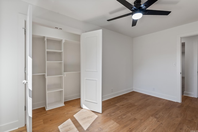 unfurnished bedroom with ceiling fan, baseboards, and wood finished floors