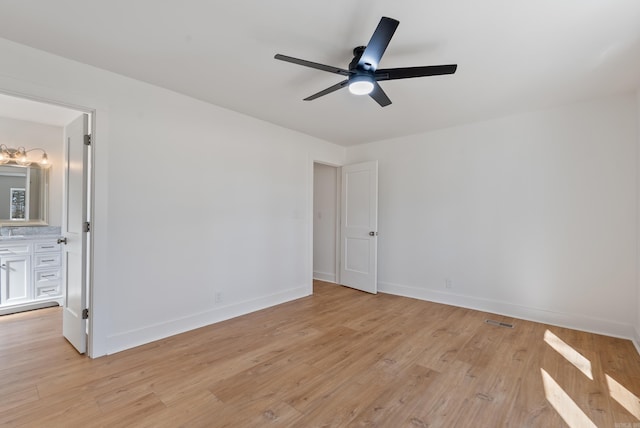 empty room with visible vents, baseboards, and light wood-style flooring