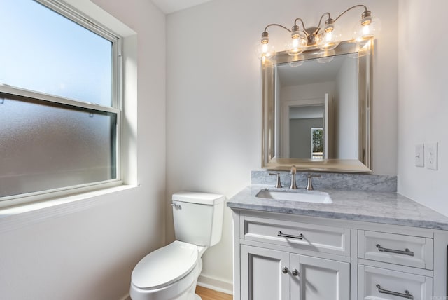 half bathroom with toilet and vanity