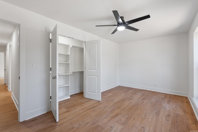 unfurnished bedroom with a closet, baseboards, and light wood-style floors