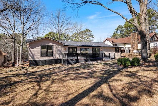 rear view of house with a wooden deck