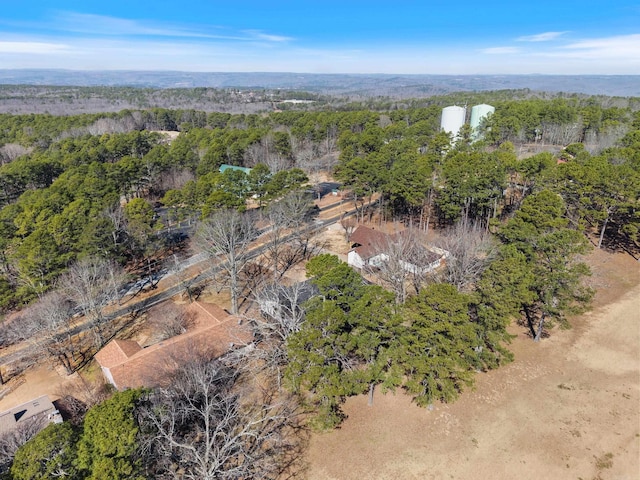 birds eye view of property featuring a view of trees