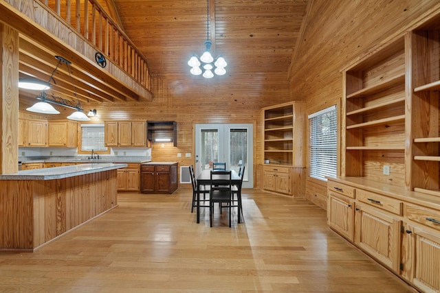 kitchen with built in features, open shelves, wood walls, wooden ceiling, and light wood-type flooring