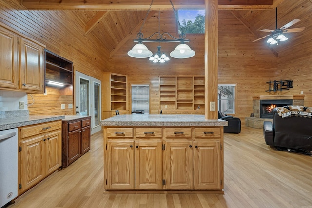 kitchen with stainless steel dishwasher, wood ceiling, wood walls, and a warm lit fireplace