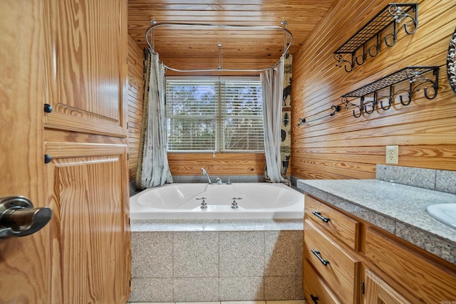 full bathroom with vanity, tiled tub, wood ceiling, and wooden walls