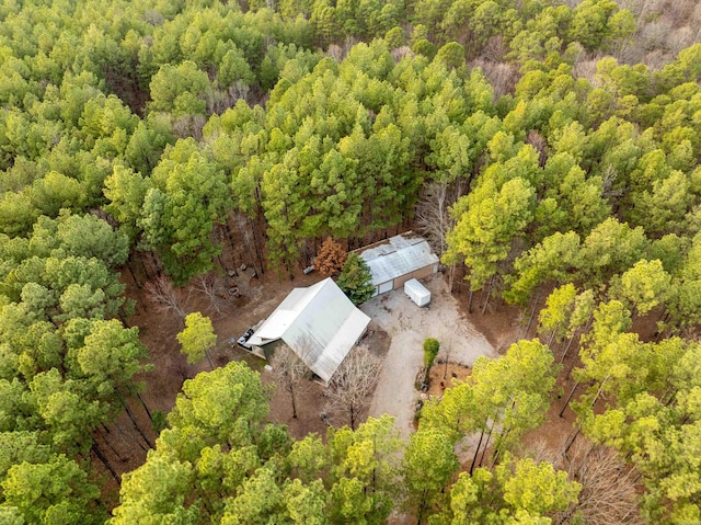 drone / aerial view featuring a wooded view