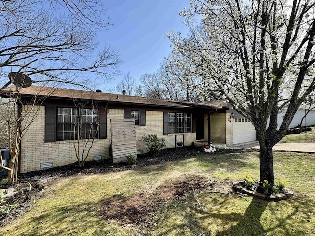 single story home with crawl space, an attached garage, a front lawn, and brick siding