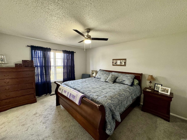 carpeted bedroom featuring a textured ceiling and ceiling fan