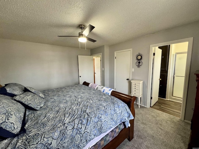 carpeted bedroom with a textured ceiling and ceiling fan