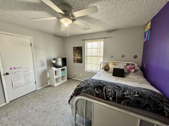 bedroom with carpet, baseboards, visible vents, ceiling fan, and a textured ceiling