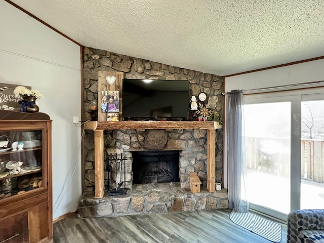 living area featuring a textured ceiling, wood finished floors, a fireplace, and vaulted ceiling