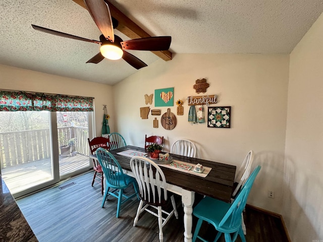 dining space with lofted ceiling with beams, visible vents, a textured ceiling, and wood finished floors