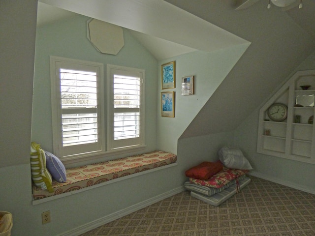 interior space featuring baseboards, lofted ceiling, and carpet floors