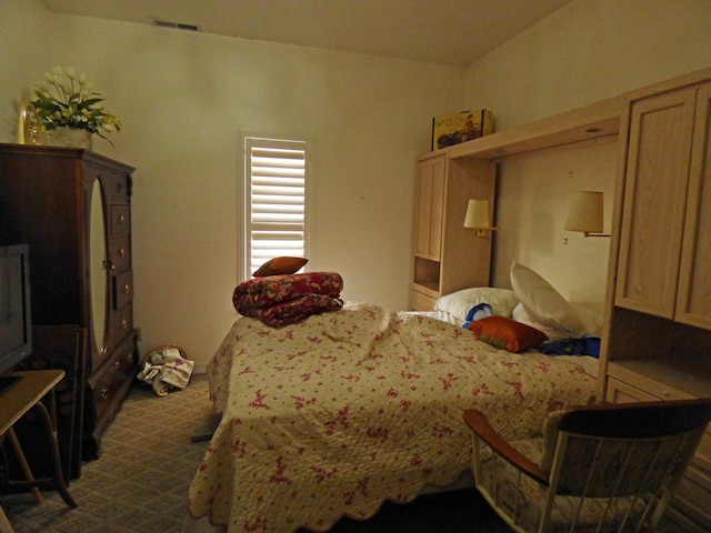 bedroom featuring visible vents and dark carpet