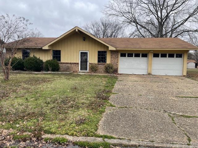 ranch-style home featuring driveway, brick siding, a front lawn, a garage, and board and batten siding