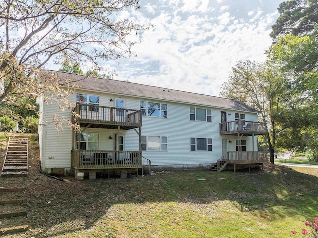 rear view of house with stairs, a wooden deck, a yard, and crawl space