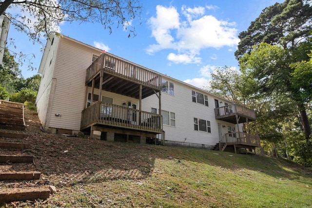 rear view of property featuring crawl space, a yard, a wooden deck, and stairway