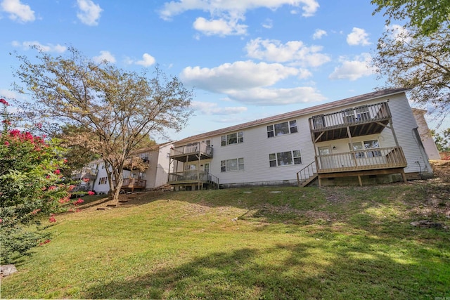 back of house featuring a wooden deck, a balcony, a lawn, and crawl space