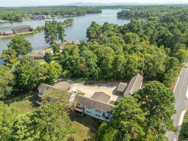 bird's eye view featuring a wooded view and a water view