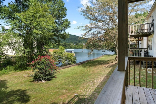 view of yard with a deck with water view