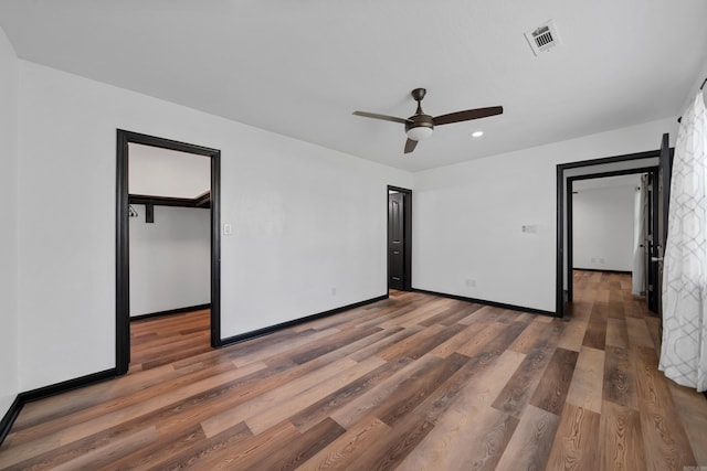 unfurnished bedroom featuring recessed lighting, visible vents, baseboards, and wood finished floors