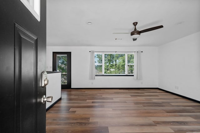 interior space with visible vents, baseboards, and wood finished floors