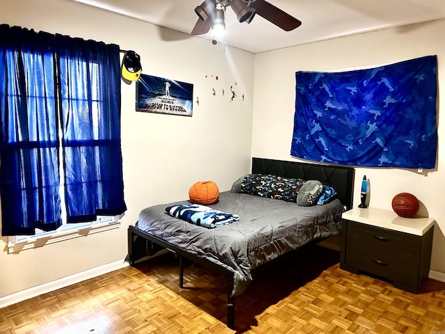 bedroom with a ceiling fan and baseboards